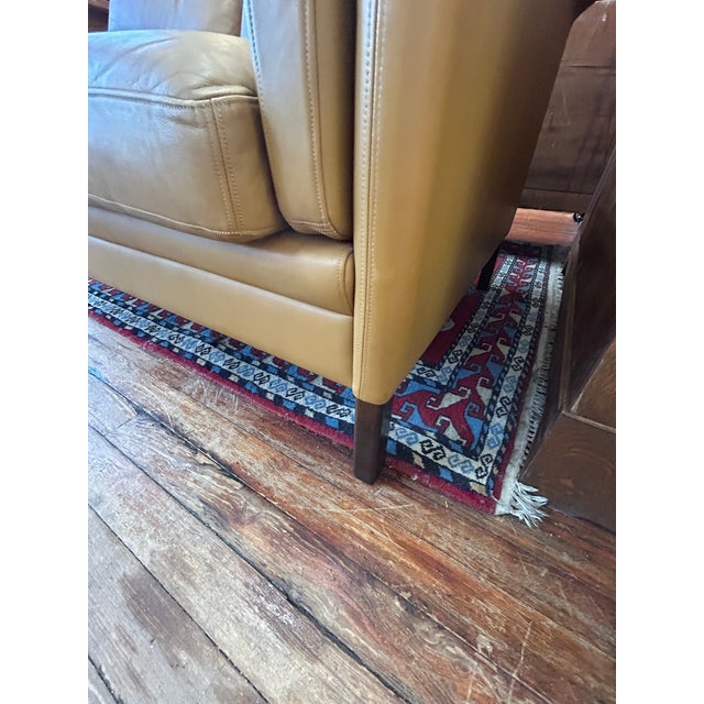 Sleek comfortable mid century modern Carmel or mustard colored leather loveseat in the manner of Borge Morgenson. No...