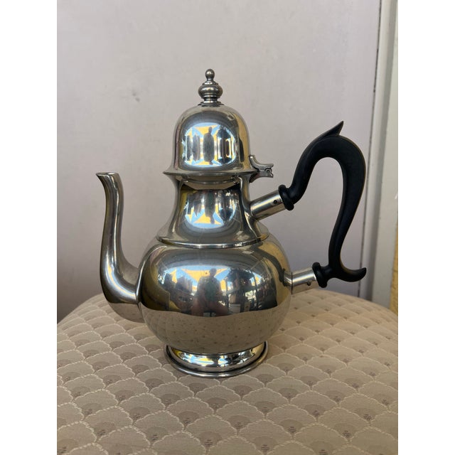 This is a vintage 1980s Kirk Stieff "Old Annapolis" polished pewter teapot featuring an ebonized black handle. I have...