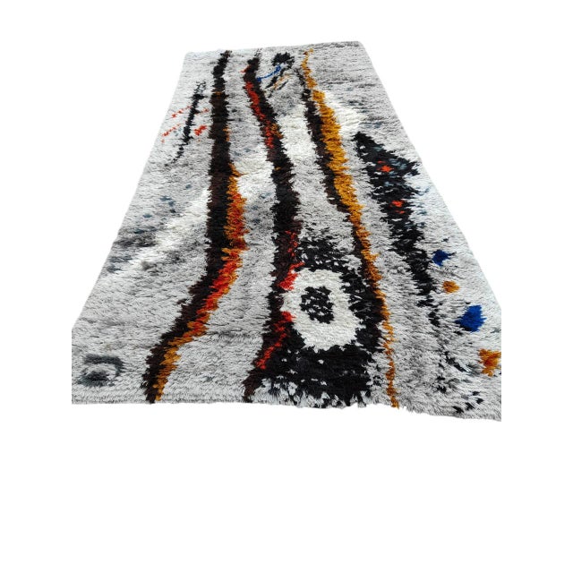 This large, hand-knotted Scandinavian wool rug is an authentic expression of 1970s Nordic design, characterized by a...