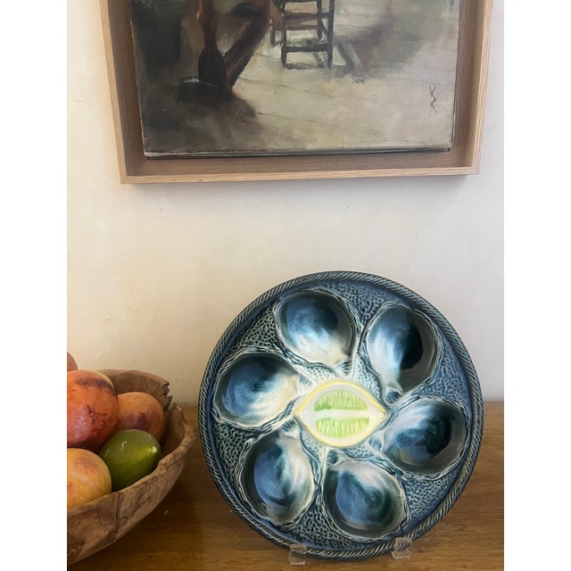 Vintage oyster plate made by St. Clement in France in the middle of the 20th century. The plate has six wells with a...