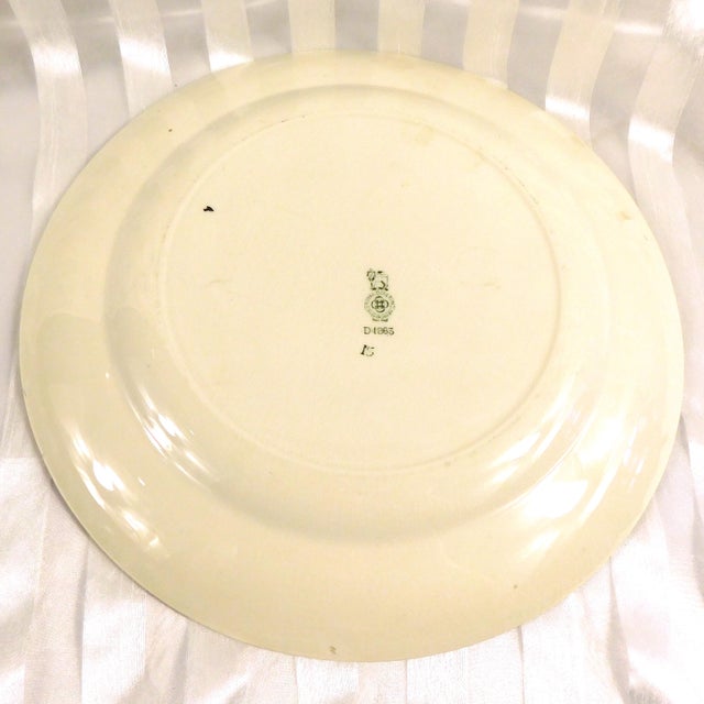 This is a Royal Doulton plate that is a thicker ceramic plate in a very colorful design. I have not been able to identify...