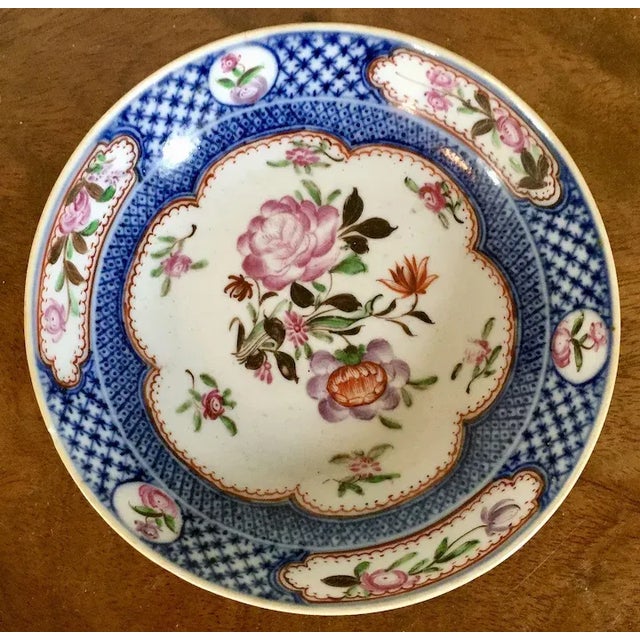 Antique 18th century Chinese Qianlong porcelain saucer dish in famille rose palette within a blue border. Decorated with...