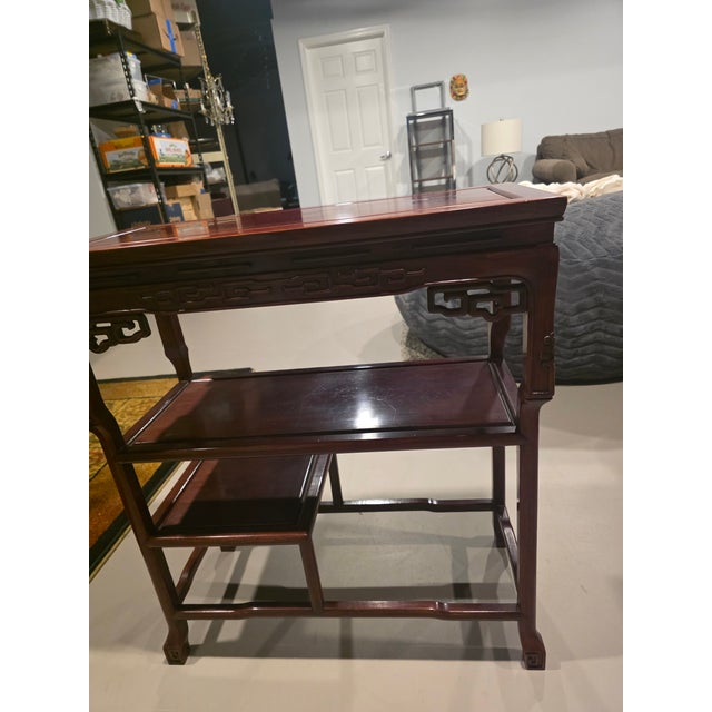 This console table reflects traditional Chinese furniture design principles that flourished during the Qing Dynasty and...