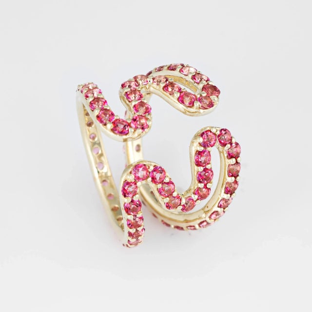 Stylish Sabine Getty pink topaz ''wiggly'' ring crafted in 18 karat yellow gold. Pink topaz totals an estimated 2.88...