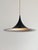 When lit, the white interior reflects a soft, even glow down onto the table below, while the dark petrol-grey outside...