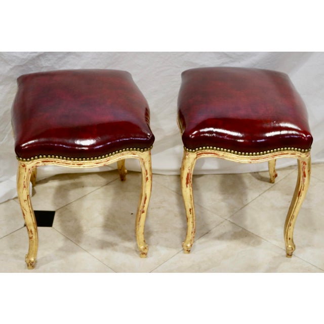 Vintage French Louis XV Ottoman or Stool Ox Blood Red Italian Leather - A Pair. The seats are trimmed with solid Brass...