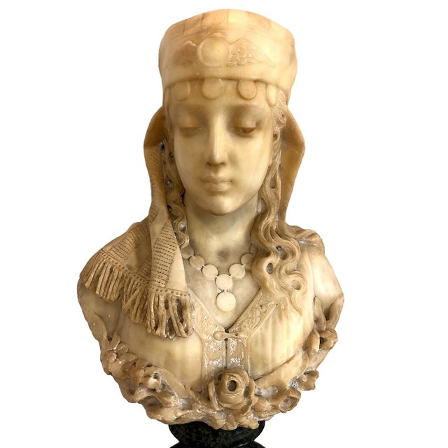 On offer is a 19th-century Italian Orientalist alabaster bust of a woman with a serene, downcast gaze, a coin necklace,...