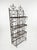 Elegant vintage wrought iron étagère featuring ornate scrollwork, fleur-de-lis finials, and a rich aged patina. This four-...