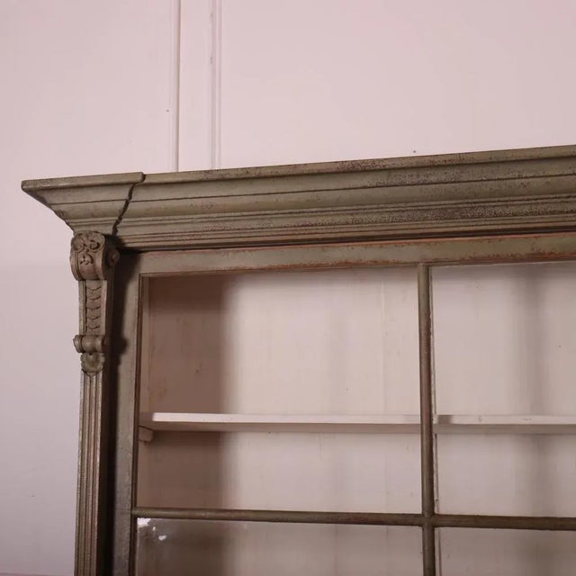 Wonderful early 19th C English glazed kitchen dresser with sliding top and bottom doors. 1830 This piece is designed in...