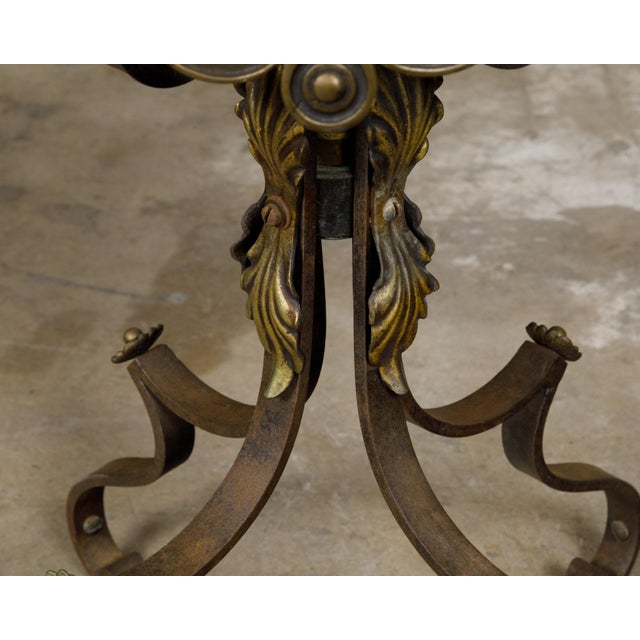 A French iron guéridon table from the 19th century with brass accents and quatrefoil inspired marble top. Born in France...