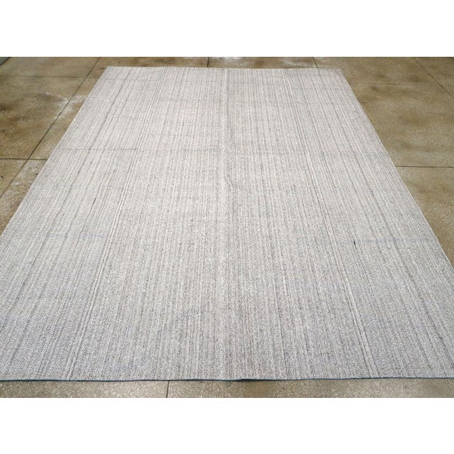 This Mid-20th century Turkish Flatweave Kilim rug, exemplifies the understated elegance and craftsmanship characteristic...