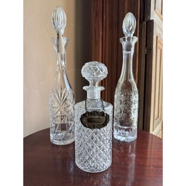 Antique cut glass crystal decanter in a tapered conical form, widening at the base and narrowing into a long neck. Early...