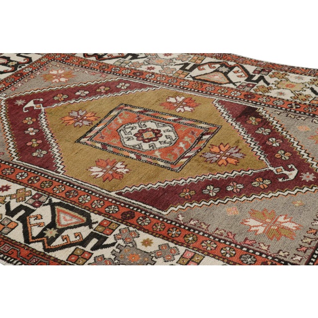 Hand-knotted in wool, this 5x9 rug originating from Turkey, circa 1950-1960, is a very special piece featuring a...