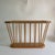 A solid, blonde wood magazine rack featuring 16 spindles and a wide, wood rim. A fun, modern yet classic form that is...