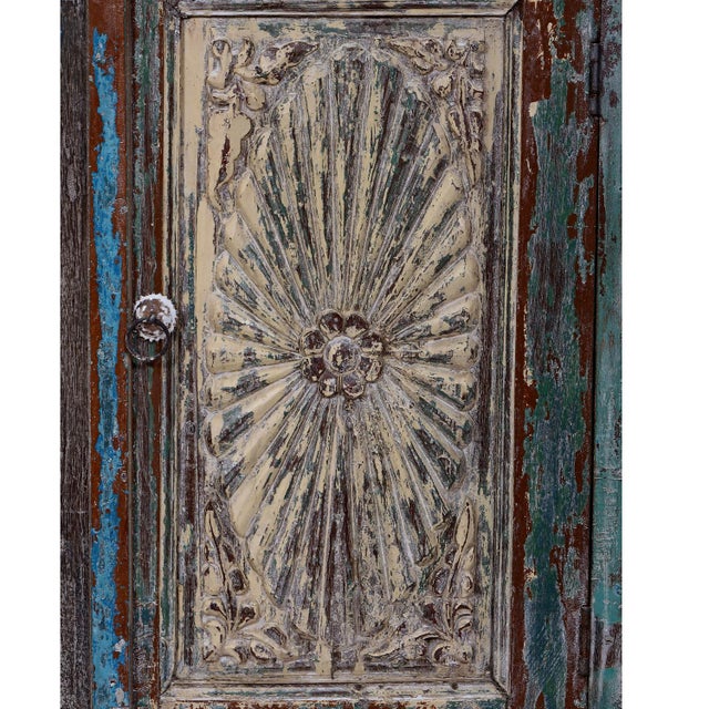 A versatile accent piece constructed from antique Indian teak architectural fragments, featuring a sunburst carved door...