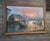 This oil painting depicts a tranquil harbor scene at sunset, framed in a rustic wooden border. Key Visual Elements Central...