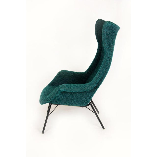 This wingback lounge chair was designed by Miroslav Navrátil in Czechoslovakia during the 1960s, a period associated with...