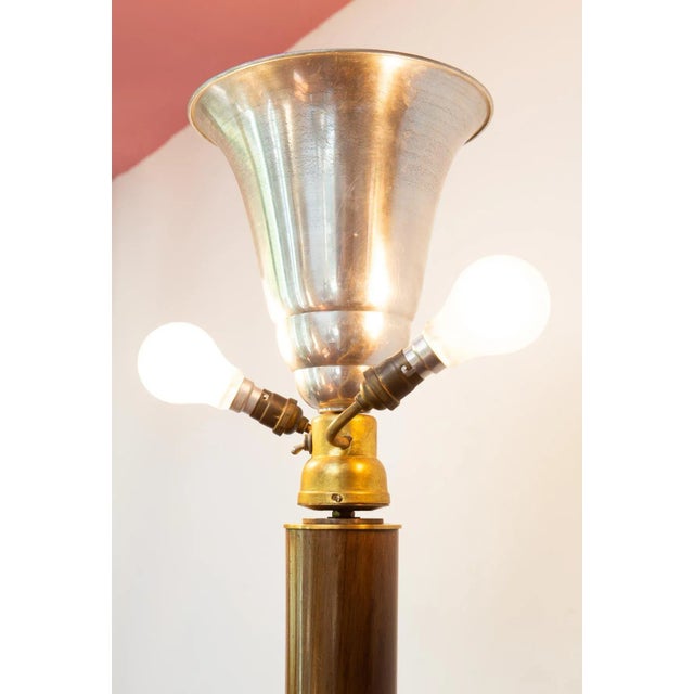 Unsigned. A large and high quality floor lamp made with different materials, such as wood, brass, gilt metal (the large...