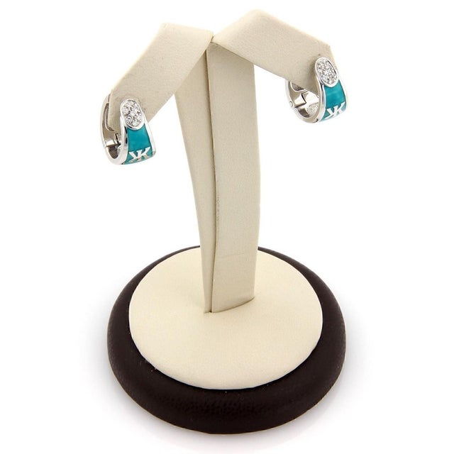 The Korloff Diamond & Enamel 18k White Gold Huggie Earrings are a luxurious and elegant pair of earrings from the vintage...