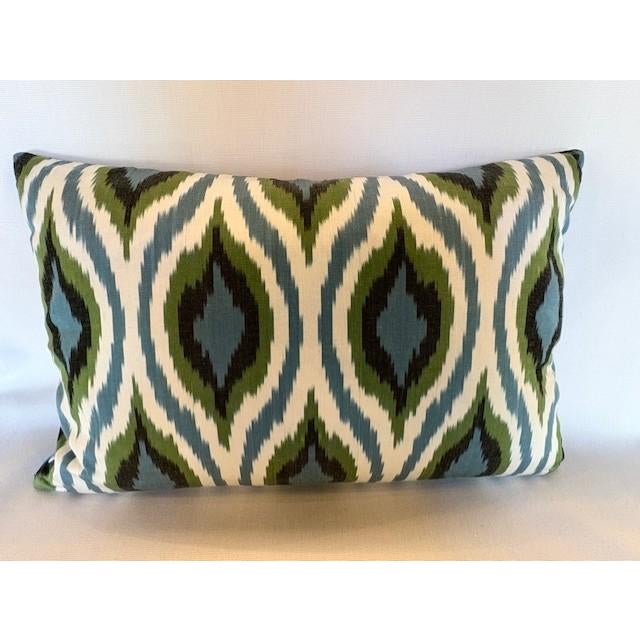 A stunning pillow from Les Ottomans embroidered in blue, green and pale yellow pomegranate motif on a cobalt blue silk....