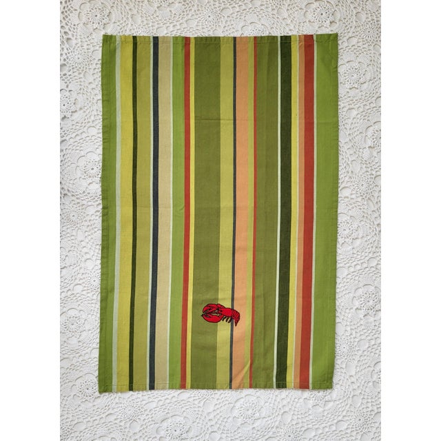 A new, hand-embroidered cotton striped lobster tea towel, measuring 19” x 28”. My mom embroidered this - isn't it a beauty?