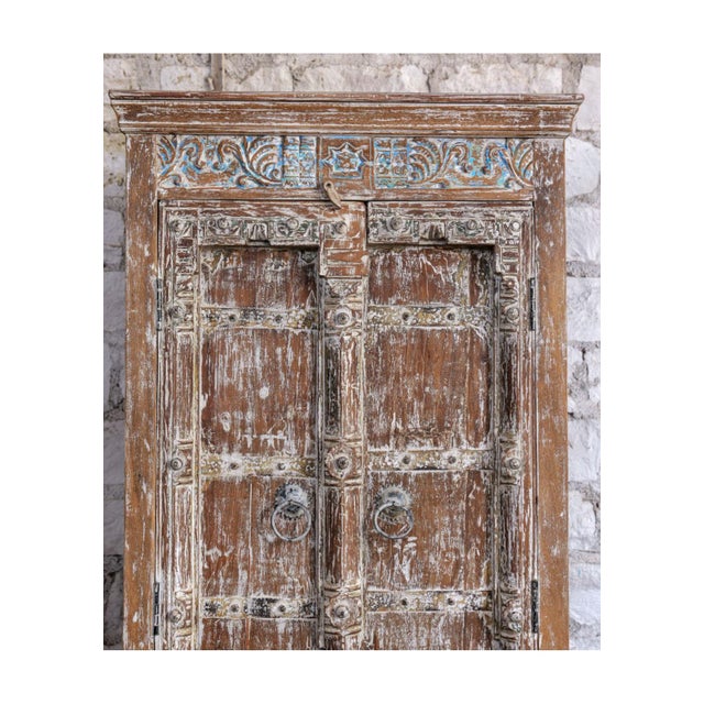Elevate your space with this antique rustic carved armoire, beautifully finished in a soft distressed whitewash that...