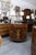 This is one of a pair of elegant English Neoclassical demilune cabinets crafted in richly figured mahogany with satinwood...