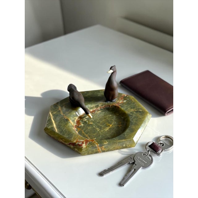 A beautifully sculptural mid-century European vide-poche or decorative catchall featuring two stylized bronze ducks...