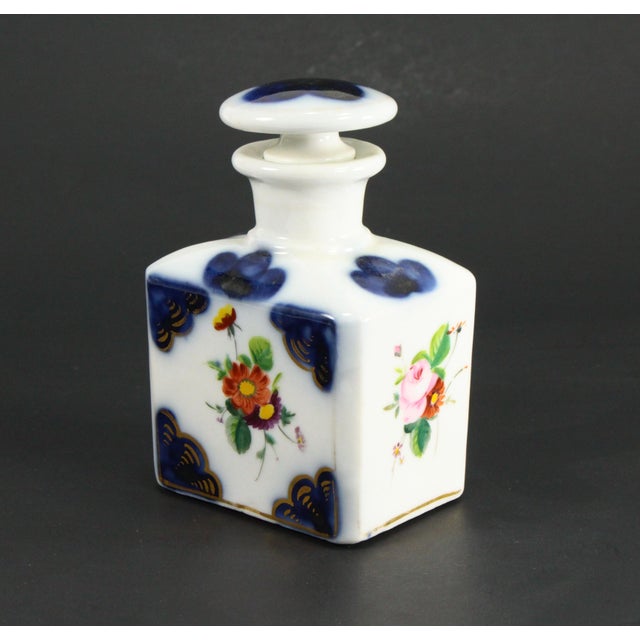 A beautiful vanity bottle Square shaped with longer neck and stopper made of withe porcelain with cobalt blue underglaze...