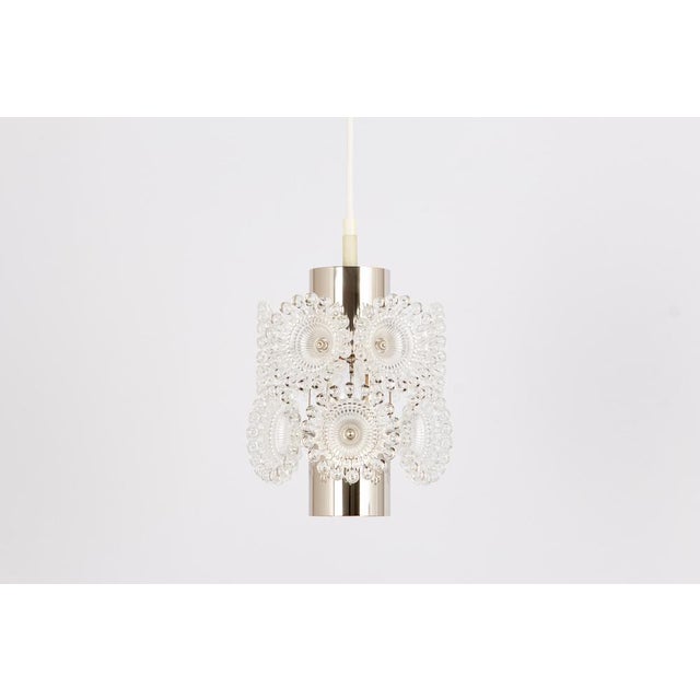 Stunning petite floral acrylic glass and chrome sputnik pendant lights, germany, 1960s. When illuminated, the pendant...