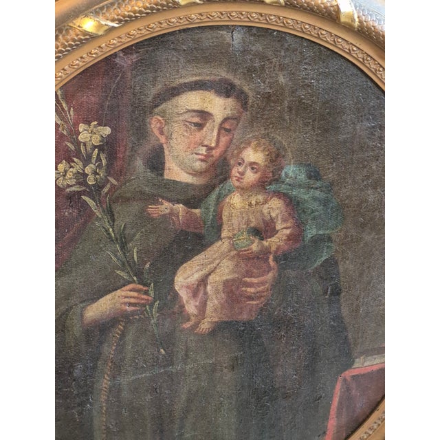17th century oil painting on canvas of a monk holding baby Jesus in the style of the Renaissance.Presented in a gilt wood...