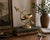 Vintage brass armillary sphere featuring an arrow passing through a circular celestial globe form on a decorative pedestal...