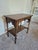 This is an antique wooden parlor or library table, showcasing distinctive design elements from the Late Victorian or...