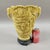 A dramatic vintage Italian chinoiserie vase dating to the 1960s–1970s, richly decorated with deeply carved courtyard and...
