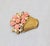 1980s goldtone molded pink resin flowers with faux-pearl centers and accents in a basket brooch with a security clasp....