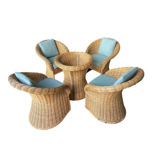 Vintage wicker dining set featuring sculptural pedestal base table and four matching barrel armchairs. Classic organic...