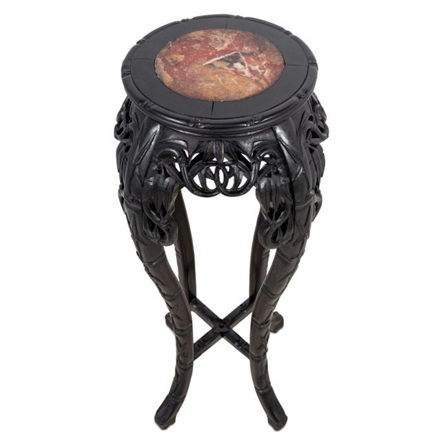 Chinese Ebonized Hardwood and Marble Pedestal Table, late 19th century, the circular inset top above a carved frieze on...