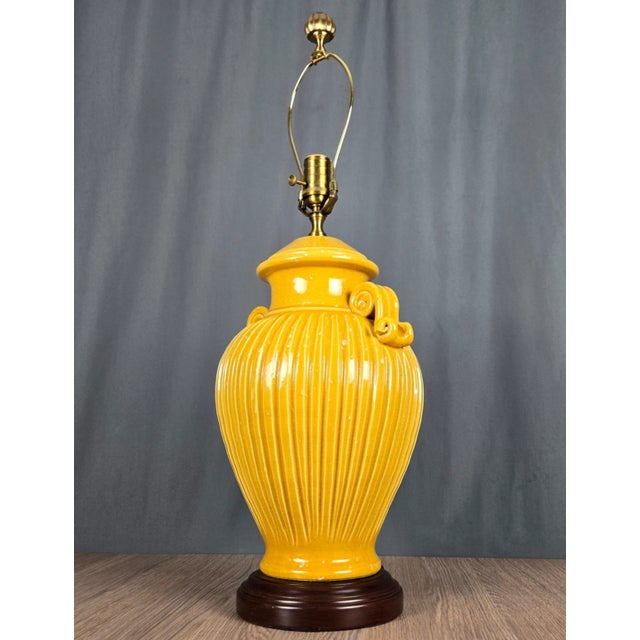 Impressive lamp by Wildwood, marked on the socket and the switch. Ribbed and handled urn or jar in a yellow crackle glaze...