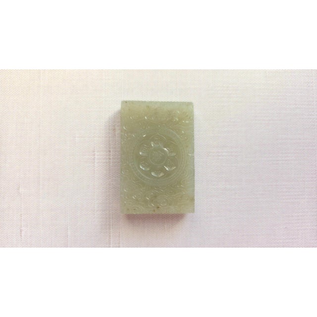 We are pleased to present a very old pendant-amulet crafted from Hetian jade, featuring a carved depiction of a lotus on...