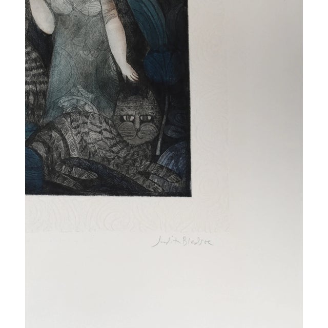 Judith Bledsoe's sweet depiction of a woman holding an umbrella is accompanied by lounging cats laying around her....