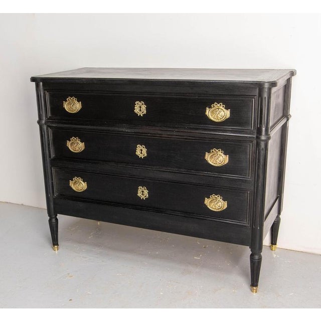 French commode chest of drawers in the Louis XVI style. Wood and brass. This chest of drawers has been refinished with...