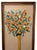 Striking tall decorative wall panel depicting a lush orange topiary tree rising from a pale blue architectural planter....