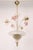 This three-arm Murano style glass chandelier features clear glass infused with fine gold leaf throughout. The design is...