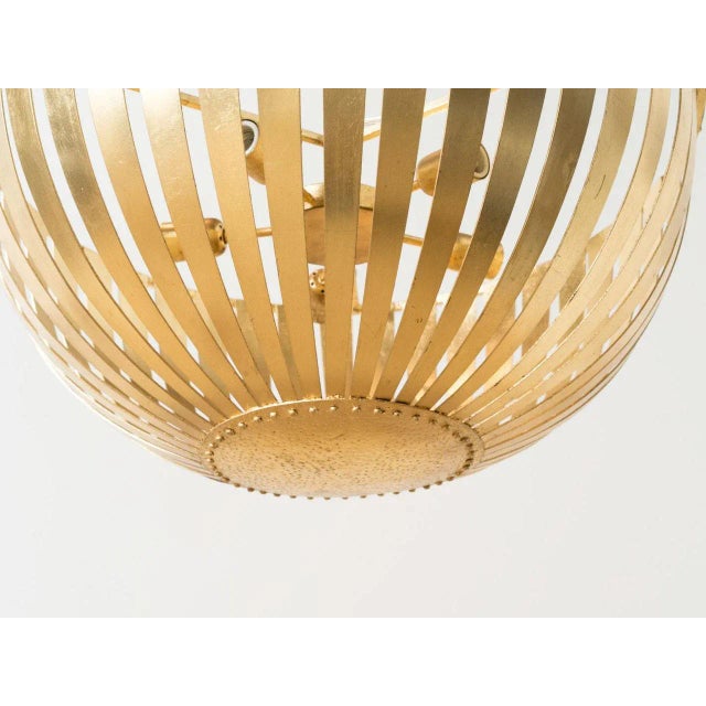 Gold leaf iron frame bowl shaped that houses five lights. Approved for use in covered outdoor areas.