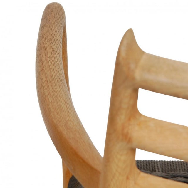 N.o møller armchair model 62 with a frame of oak and seat of black wicker. The chairs appear in good condition but with...