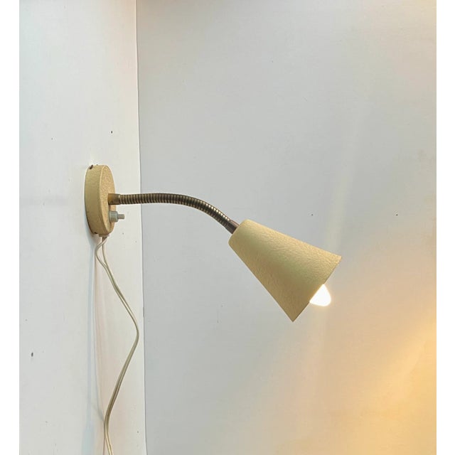 Fully adjustable wall lamp made from aluminium applied with a 1950s characteristic pastel yellow texture paint (all...