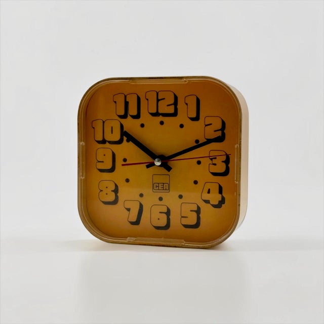 Vintage Space Age wall clock by CEA, dating stylistically to the 1970s. The compact rounded-square case is made from amber...