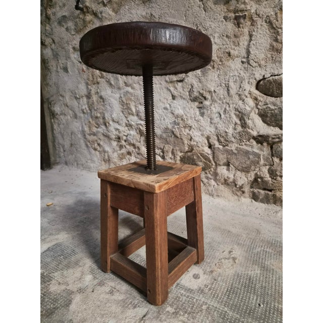 An antique French workshop stool dating from the early 20th century. The stool is made of solid oak and features an...
