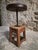 An antique French workshop stool dating from the early 20th century. The stool is made of solid oak and features an...