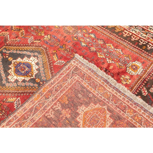 Hand-knotted Persian Qashqai rug, semi-antique. Woven in wool. The rug features a large central diamond medallion within a...